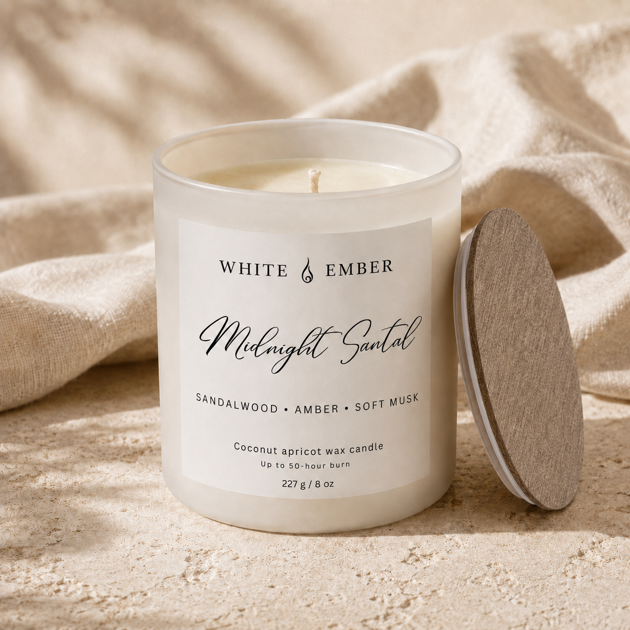 White Ember Midnight Santal frosted candle with a thin iridescent wooden lid